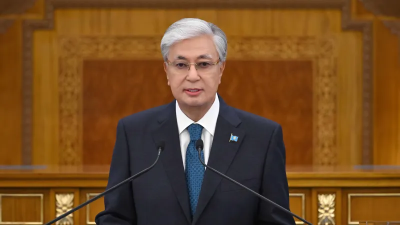 Kazakhstan President Kassym-Jomart Tokayev speaking at a lectern during his 2025 Address to the Nation