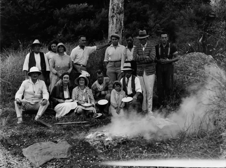 Group portrait of people gathered outdoors cooking food (AM 78899-1)