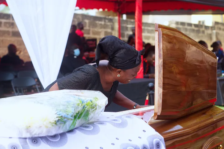 A mourner expressing sorrow for the deceased