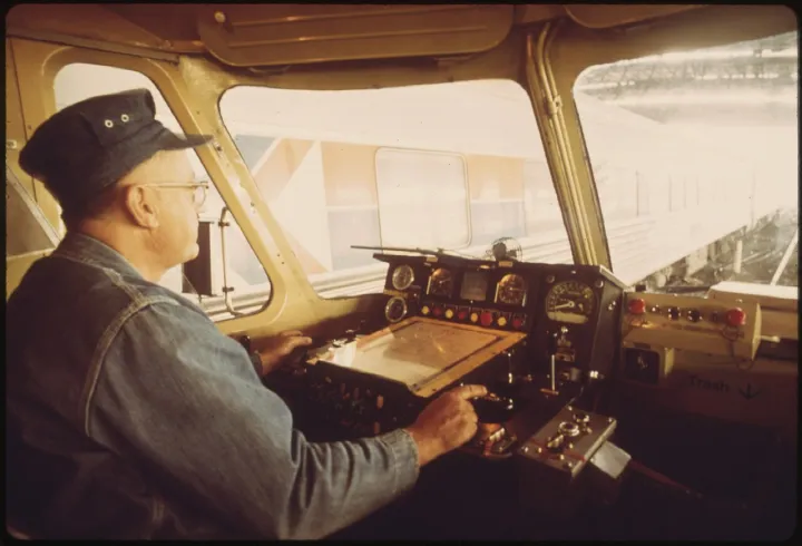 ENGINEER AT THE CONTROLS OF THE AMTRAK TURBOLINER PASSENGER TRAIN AT ST. LOUIS, MISSOURI. TWO TURBOLINERS WERE LEASED... - NARA - 556060