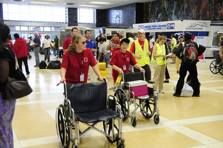 Volunteers go to arriving trains to help returning evacuees in Louisiana