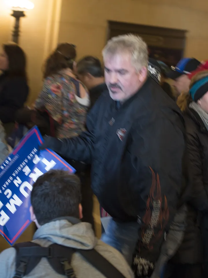 Trump supporter blocks the camera of a photographer (32412730234)