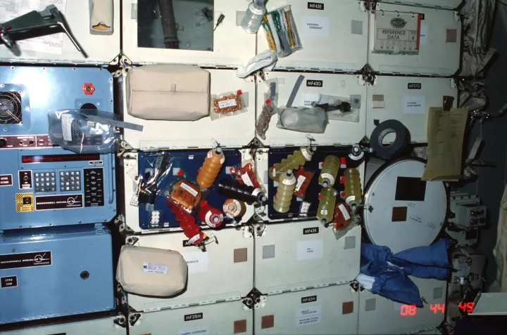Columbia, OV 102, forward middeck locker experiments and meal tray assemblies, NASA