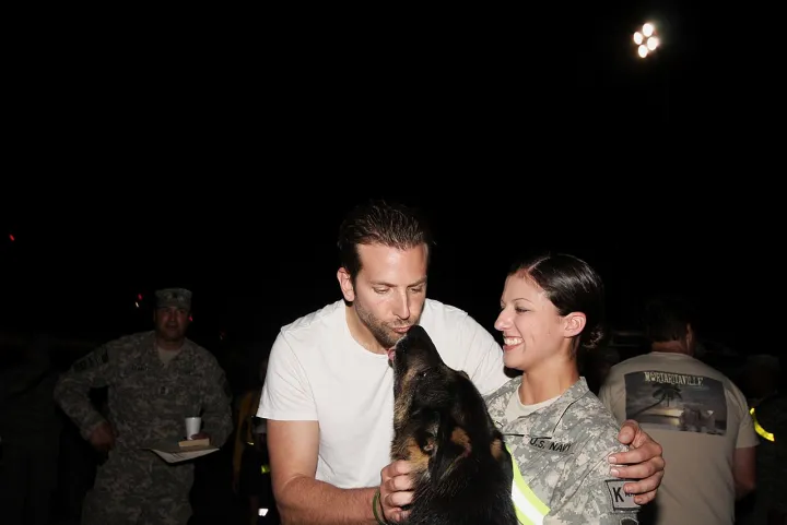 Bradley Cooper kisses dog
