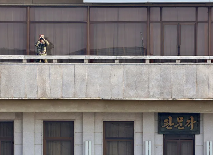 North Korean Soldier Observes South Korea (9383230)