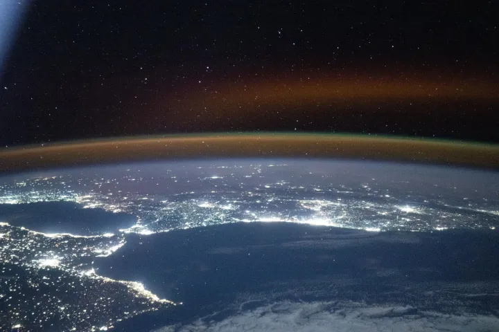 A red yellow airglow blankets Earth's horizon above southwestern Europe and North Africa, NASA