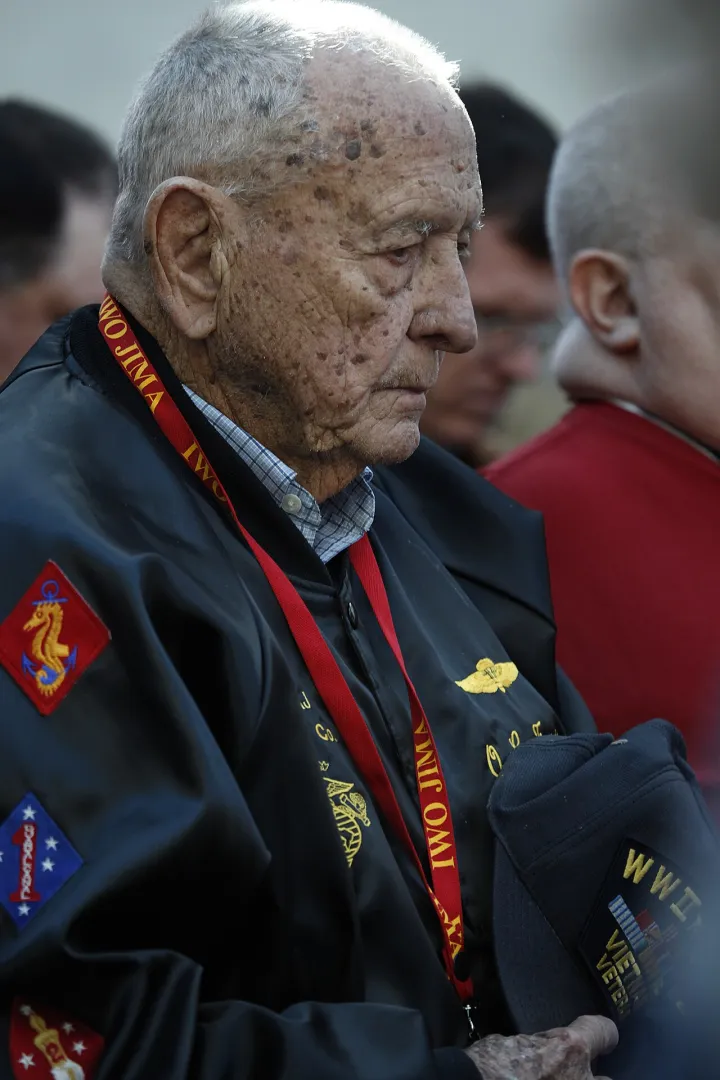 Marine veteran prays during ceremony (4374071396)