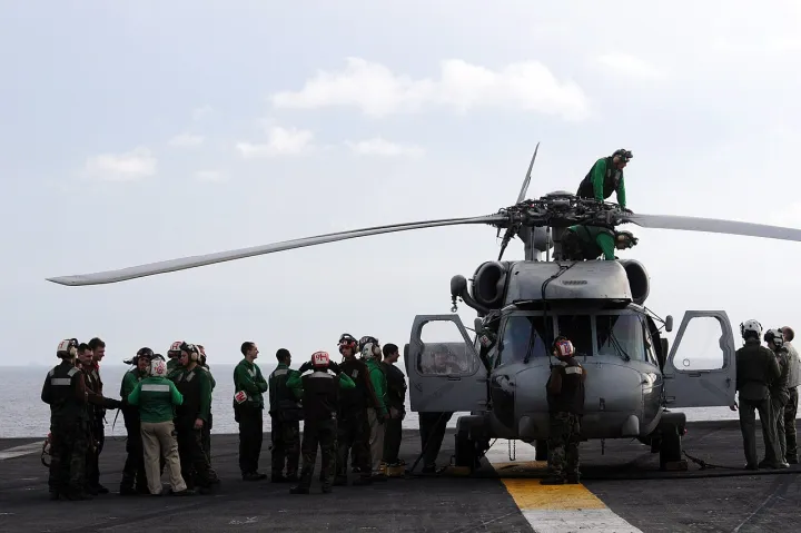 US Navy 080630-N-3659B-086 Flight deck personnel stand by as last minute maintenance is performed on an SH-60F Seahawk