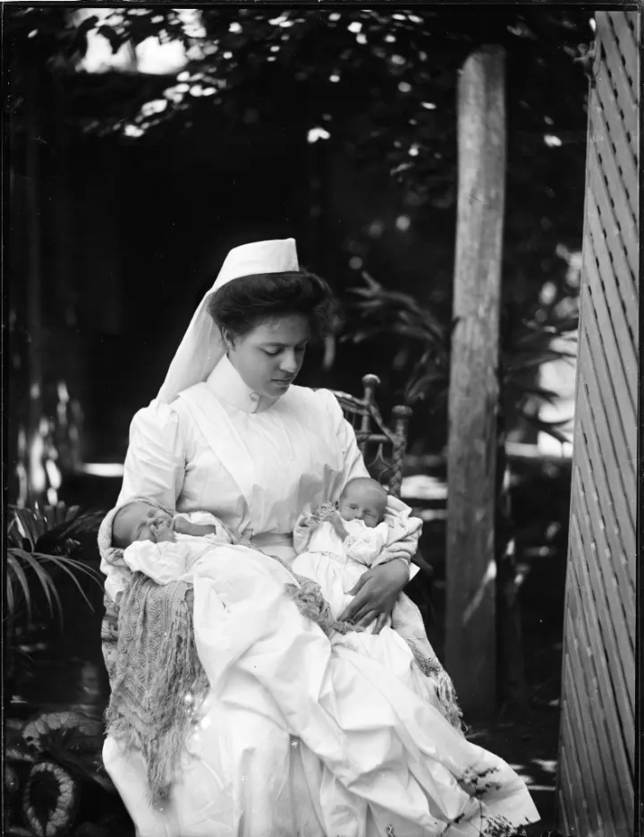 View of portrait of a seated woman holding twin babies, one in each arm (3332680896)