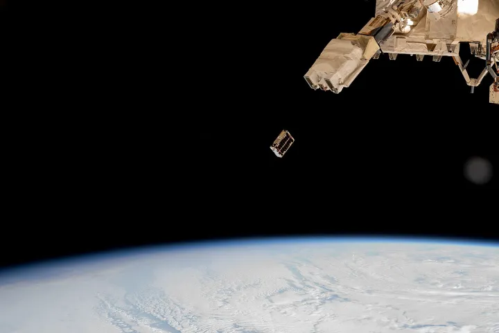 A CubeSat is ejected into Earth orbit from a small satellite orbital deployer (iss072e352235)