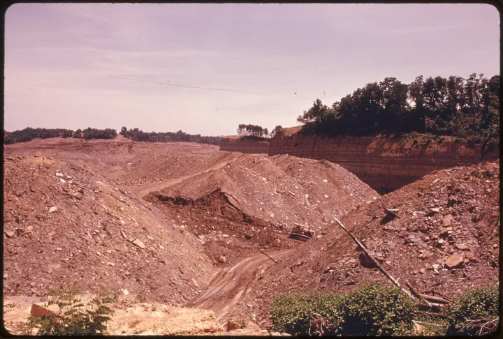 BUTTES, MESAS AND CANYONS REMAIN AFTER COAL COMPANIES HAVE STRIP MINED OFF ROUTE ^800 NEAR BARNESVILLE, OHIO - NARA - 555614