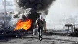 Burning tyres and masked man imaged during clashes between Palestinians and Israeli forces, Shuafat, 2009