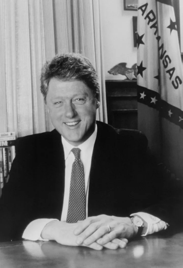 President Bill Clinton, half-length portrait, seated at desk, facing front